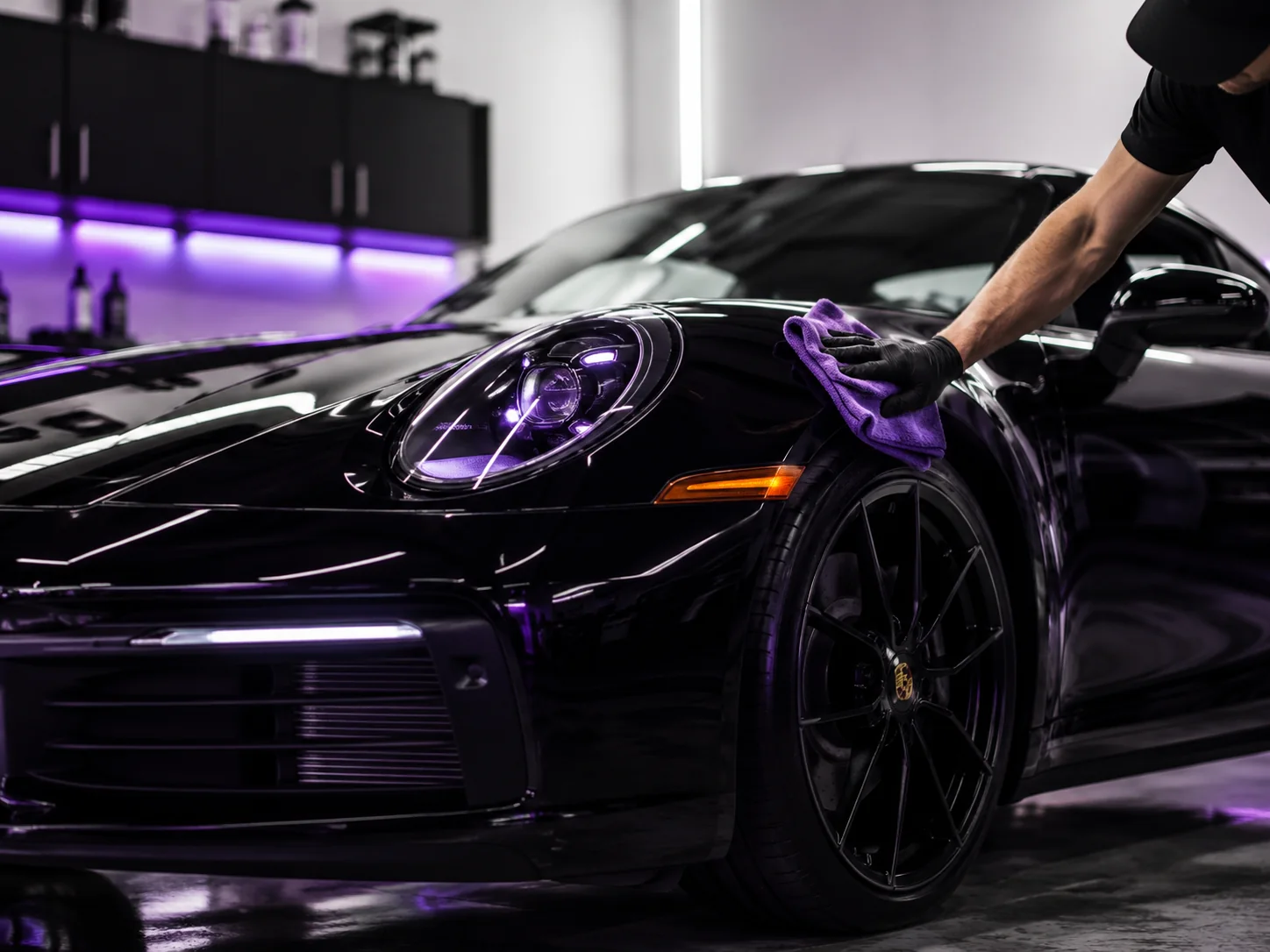 Premium car detailing studio with AutoCleanify purple lighting